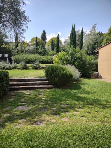 a garden with stairs and trees and grass at Tenuta del Podestà villa di charme in Florence