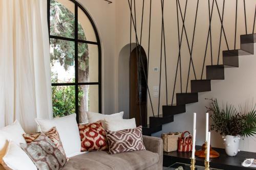a living room with a couch and a staircase at Tenuta del Podestà villa di charme in Florence