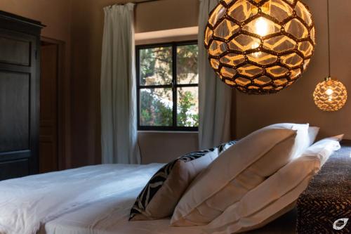 a bedroom with a bed with pillows and a window at Tenuta del Podestà villa di charme in Florence