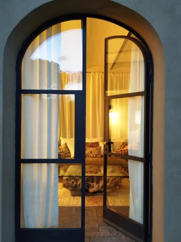 an arched window in a room with a bedroom at Tenuta del Podestà villa di charme in Florence