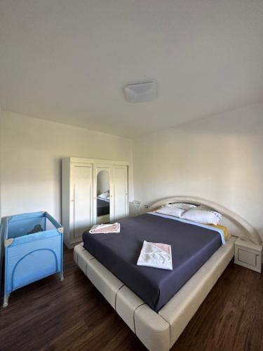 a bedroom with a large blue bed in a room at Vila Jovanka in Tivat