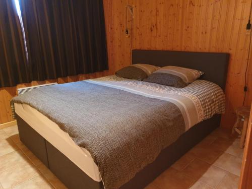 a bed with two pillows on it in a room at Chalet Bonne Humeur in Houffalize
