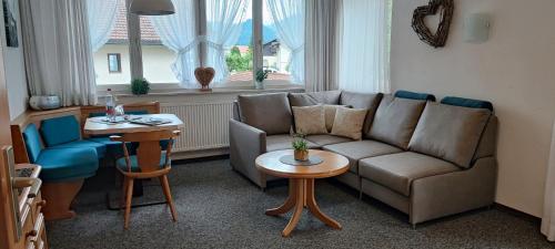 a living room with a couch and a table at Haus Eggensberger in Fischen