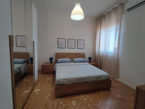 a bedroom with a bed and a mirror at La casa sui tetti in Catania
