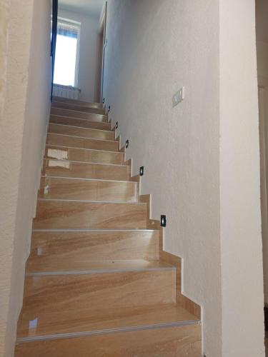 a staircase in a house with wooden floors at Rooms Lida & Friendly home in Plav