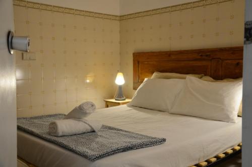 a bedroom with a bed with two towels on it at RIA Terrace in Faro