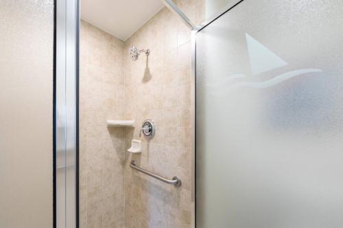 a shower with a glass door in a bathroom at Marriott's Cypress Harbour Villas in Orlando