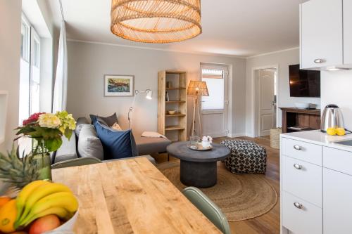 a kitchen and living room with a table and a couch at Welle 11 Sylt in Westerland (Sylt)