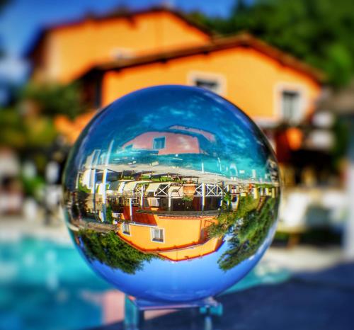 a glass ball with a reflection of a building at Agriturismo Villa Le Vigne in Montevarchi