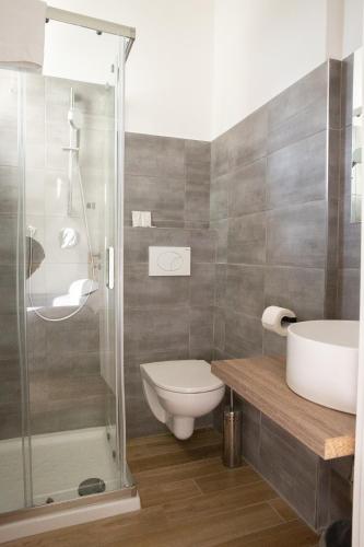 a bathroom with a shower and a toilet and a sink at Villa Ella by Interlux in Rimini