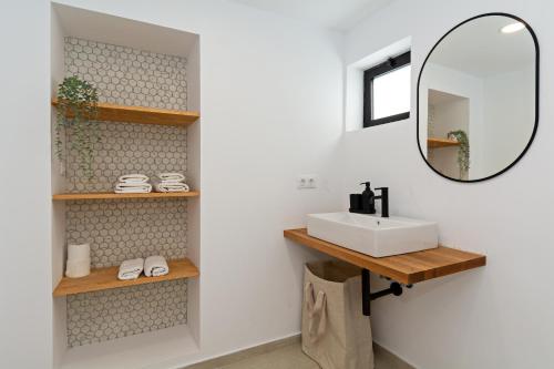 a bathroom with a sink and a mirror at Luxury Beach Views 2BR House - Private Parking in Arrecife