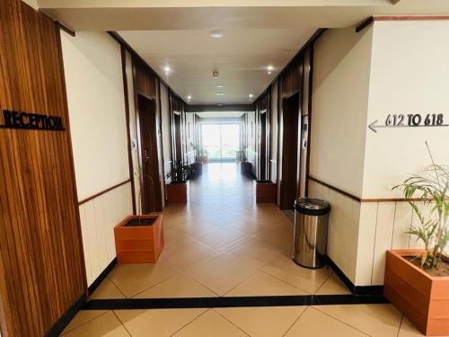 a hallway of an office building with a long hallway at The Lemon Grass Hotel in Gandhinagar