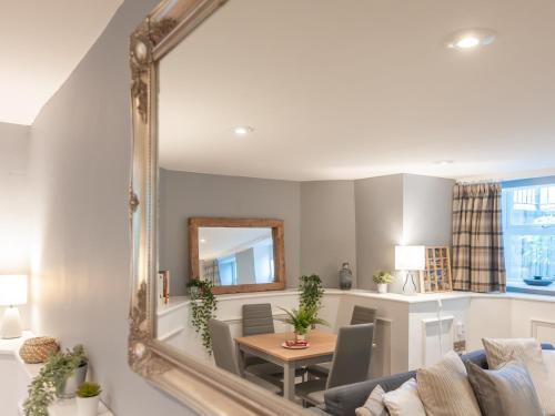 a living room with a mirror and a table at A Hidden Gem - Summer Bliss near Roundhay Park - Pass the Keys in Leeds