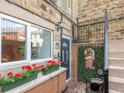 a brick building with flowers on a window ledge at A Hidden Gem - Summer Bliss near Roundhay Park - Pass the Keys in Leeds