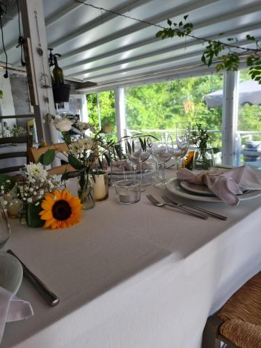 a white table with glasses and flowers on it at Agriturismo Villa Le Vigne in Montevarchi