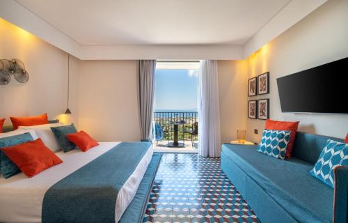 a hotel room with two beds and a flat screen tv at Gargiulo Resort in Sant'Agnello