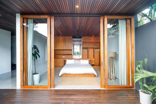 a bedroom with a bed inside of a house at Amazing 3BDR-Villa Canggu/Seseh 2min walk to Beach in Canggu