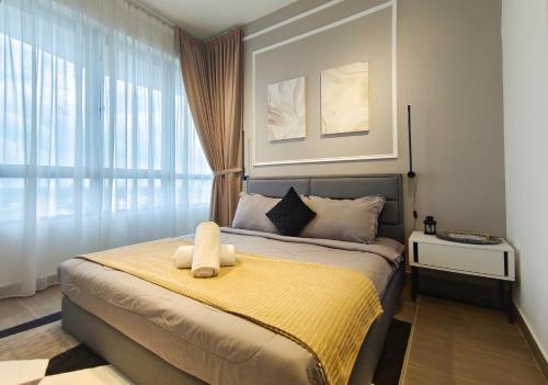 a bedroom with a bed with a yellow blanket at One Bedroom Troika Kota Bharu by AGhome, Modern Design in Kota Bharu