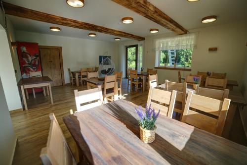 a dining room with a wooden table and chairs at Lawendowy Staw in Cisna