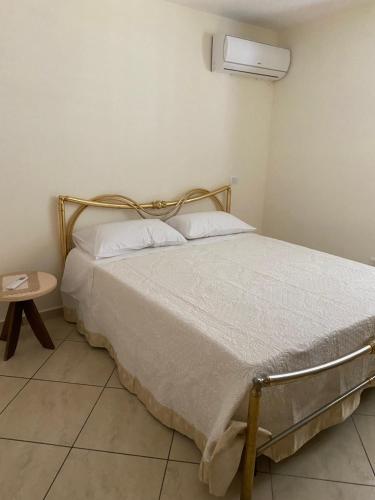 a bedroom with a bed and a small table at Casa di Antonia in San Marzano sul Sarno