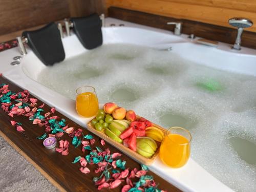 a bath tub filled with water with fruit and juice at Defne Bungalow Yomra in Yomra