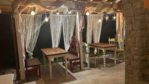 a table and chairs in a room with curtains at Agriturismo Villa Le Vigne in Montevarchi