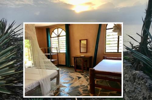 een slaapkamer met een bed en een raam en planten bij Room in Villa - 38m2 Turtle Suite in a 560 m2 Villa, Indian Ocean View in Shimoni