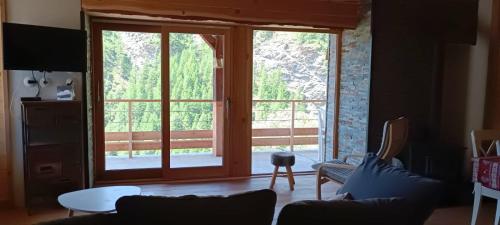 a living room with a large sliding glass door at Les Hauts du Roux in Abriès