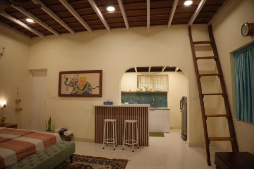 um quarto com uma cama e uma cozinha com uma escada em Cascara Beach Resort em Varkala