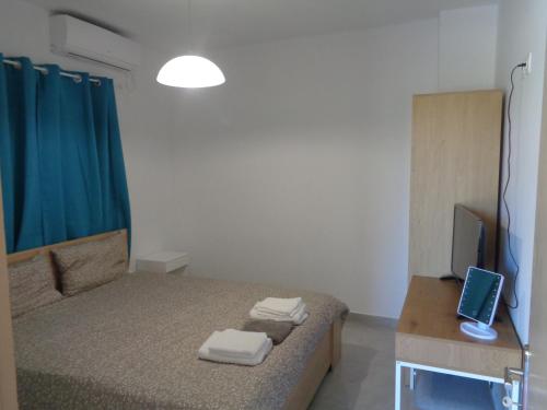 een slaapkamer met een bed en een bureau met een laptop bij La casetta in Roda