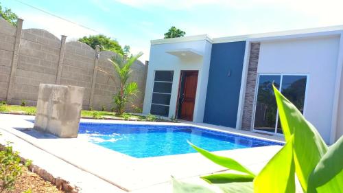 a swimming pool in front of a house at Casa Bahía Ale, Bahía Ballena Uvita in Uvita