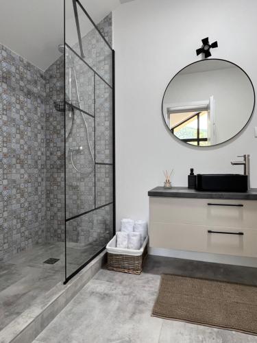 a bathroom with a shower and a sink and a mirror at Tinutul Luanei Village in Bozioru