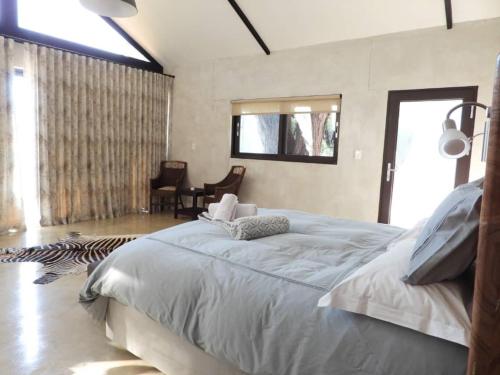a bedroom with a large bed in a room at Ibenstein Safaris in Dordabis