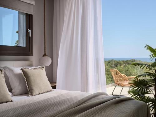 a bedroom with a bed and a large window at Kapodistria Luxury Villas - Serene Escape in a Scenic, Secluded Location, by ZanteWize in Plános