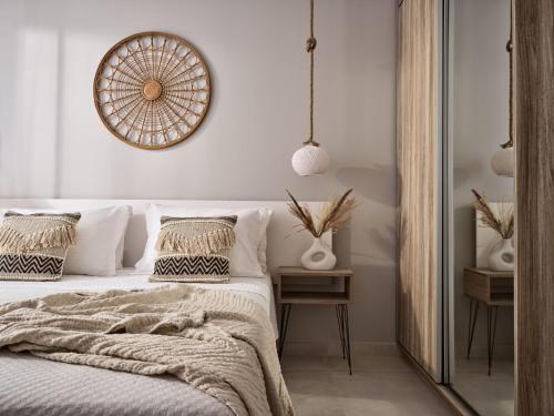 a bedroom with a bed with a blanket and a mirror at Kapodistria Luxury Villas in Plános
