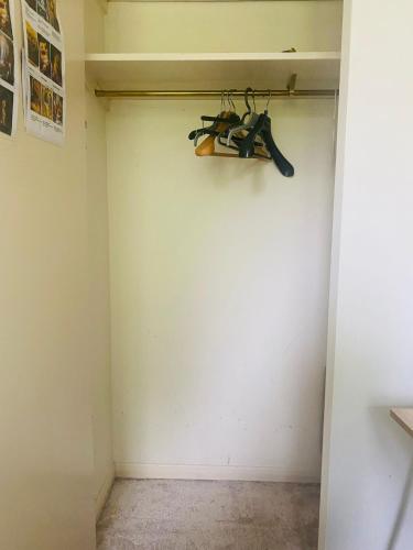 a closet with a pair of skis hanging on the wall at Private Double Room available in Hampshire in Liphook