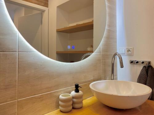 a bathroom with a white bowl sink and a mirror at B10 Apartments Bulvár in Žilina