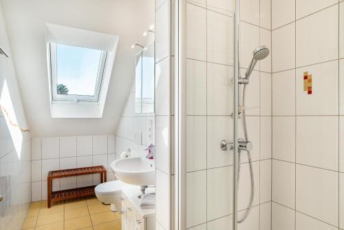 a white bathroom with a shower and a sink at Schwalbenhof Dreßler und Duss für 2 Personen in Bad Herrenalb