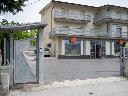 a building with a parking lot in front of it at Dino's Rooms in Lioni