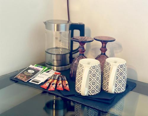 a shelf with three vases and a blender on it at HABITARE Lecce & Salento in Lecce