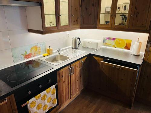 a kitchen with a sink and wooden cabinets at TOP lokalita u Pražského hradu! in Prague