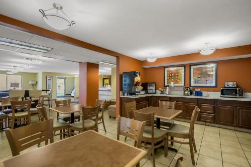 a restaurant with tables and chairs and a kitchen at Americas Best Value Sandman Inn in La Grande