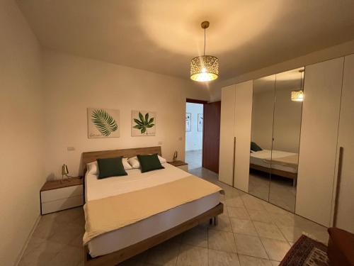 a bedroom with a large bed and a mirror at Casa Nella in Passignano sul Trasimeno