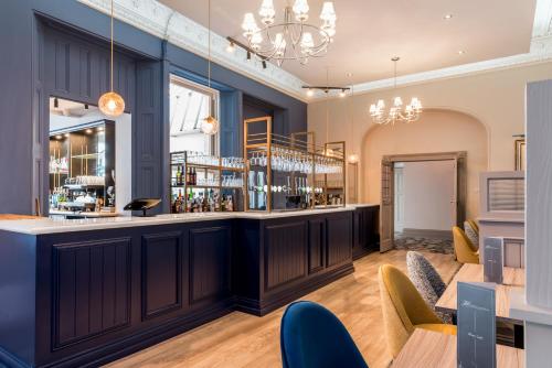 a bar in a room with tables and chairs at The Headland Hotel & Spa in Torquay