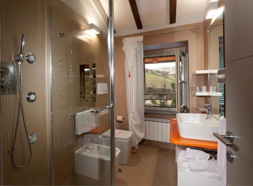 a bathroom with a shower and a toilet and a sink at Coldimolino Resort in Gubbio