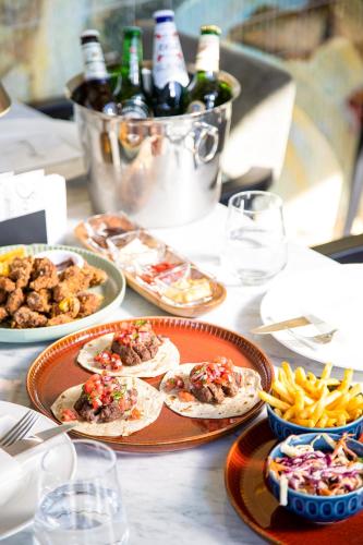 a table with plates of food and bottles of wine at Hilly Hotel in Edirne