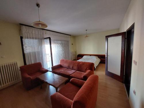 a living room with a couch and a table at City Park Rooms in Vranje