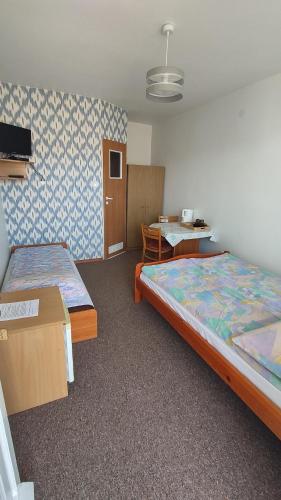 a hotel room with two beds and a table at Pokoje Renata Gaffke in Władysławowo