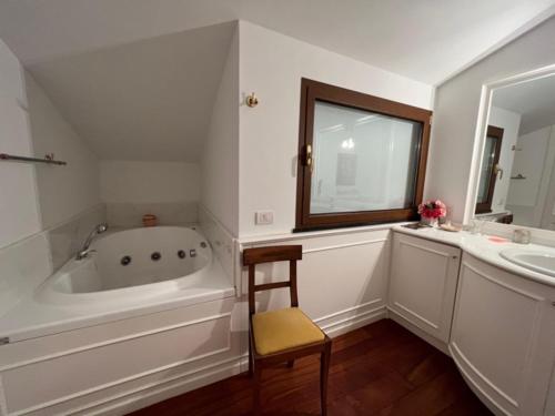 a bathroom with a tub and a sink and a mirror at Camogli - "Casa Oliver" - Liguria Holidays in Camogli