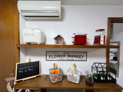 a counter with a flower market sign on a shelf at in&out apartment - mostacciano, eur in Rome